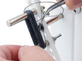 Using tweezers to place the end of material